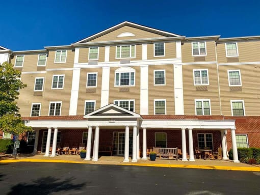 Exterior view of Park View at South Pantops, a senior apartment community in the Carriage Hill area near Charlottesville, featuring well-maintained buildings, landscaped grounds, and convenient on-site parking for adults age 62 and better.
