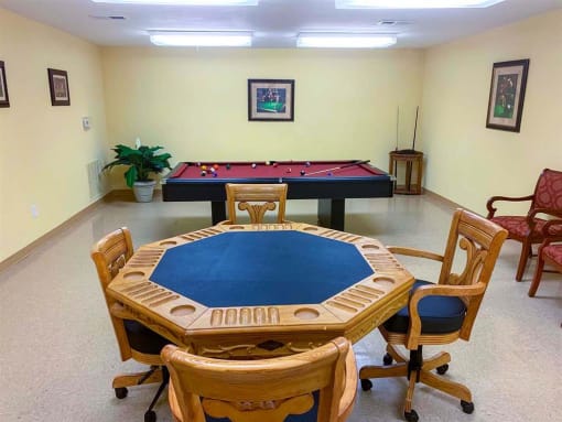 Resident game area at Park View at South Pantops featuring a card table and billiards table, offering seniors age 62+ a welcoming space for connection, recreation, and socializing with neighbors.