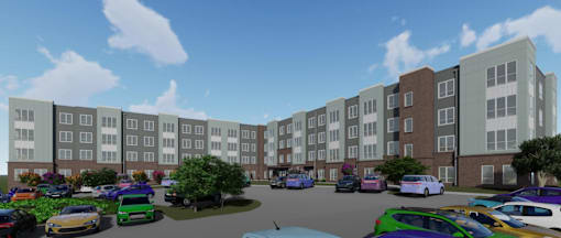 A parking lot with cars and a bus in front of apartment buildings.