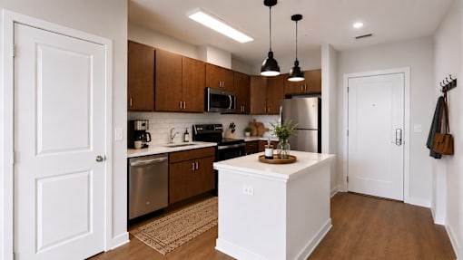 A kitchen with a white island in the middle and wooden cabinets.