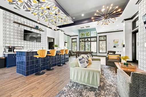 A modern living room with a bar area and a television.