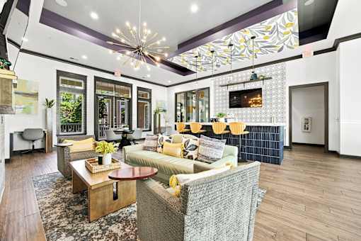 A living room with a grey couch and a wooden coffee table.