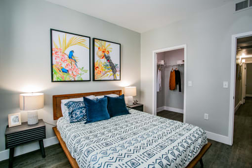 Octave Apartments a bedroom with a large bed and two paintings on the wall