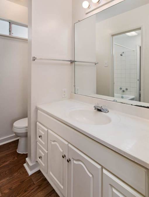 A white bathroom with a toilet and sink.