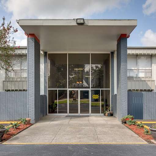 a photo of the front of a building with a large glass door