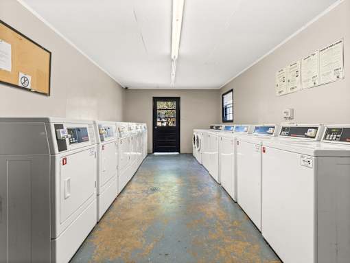 A row of washing machines in a laundromat.