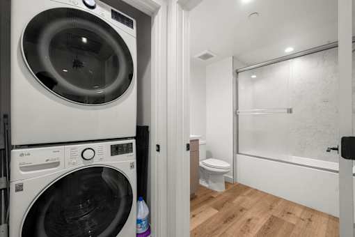 A white washing machine and dryer in a small laundry room.