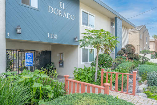 The entrance to a building named El Dorado with a blue sign indicating it is handicap accessible.