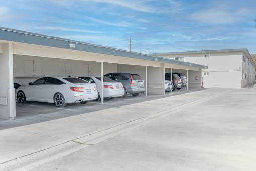 A parking garage with several cars parked in it.