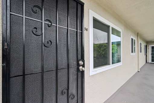 A black gate with a number 36 on it.