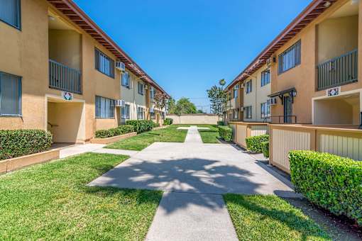 view of outside area between buildings at Serrano Apartments, West Covina, CA