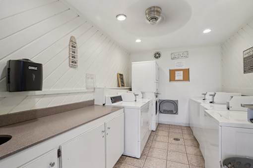 A white bathroom with a sink and toilet.