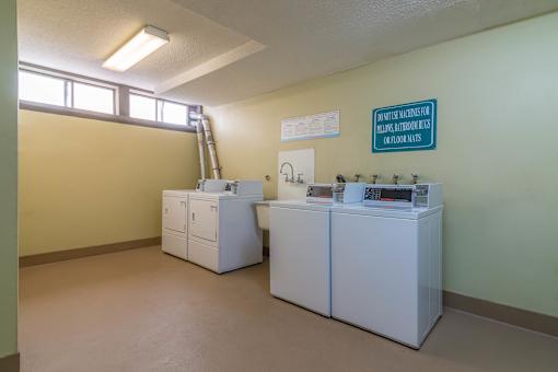 A room with a yellow wall and a sign that says "Open for inspection Monday to Friday 8am to 5pm.".