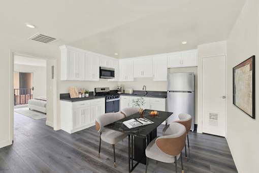 A modern kitchen with a dining table and chairs.