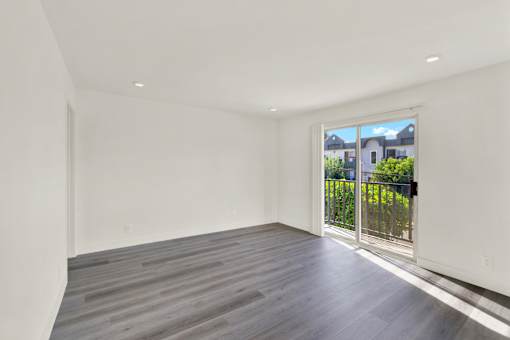 A room with a view of a house through the window.