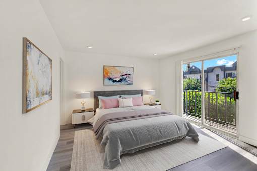 A bedroom with a large bed and a painting on the wall.
