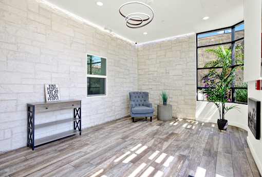 A room with a white brick wall and a wooden floor.
