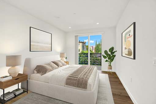 A bedroom with a large bed and a view of the city.