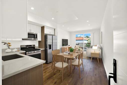 A modern kitchen with a dining table and chairs.
