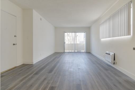 A room with a window and a radiator on the wall.