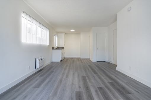 A room with a wooden floor and white walls.