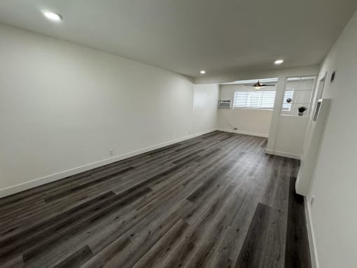 a living room with wood floors and white walls