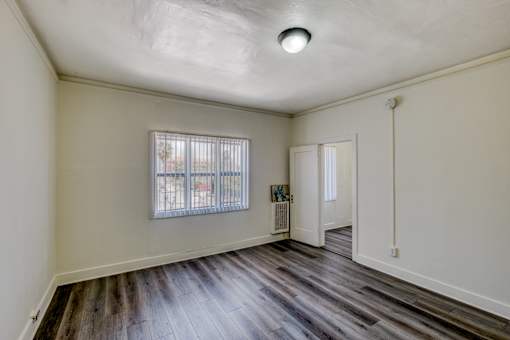 A room with a window and a door.