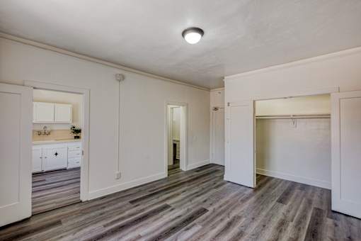 A room with a wooden floor and white walls.
