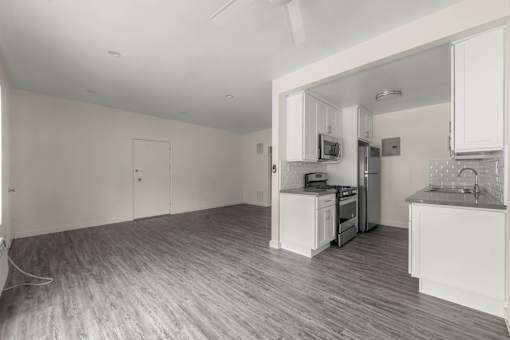 a kitchen and living room with a stove and refrigerator