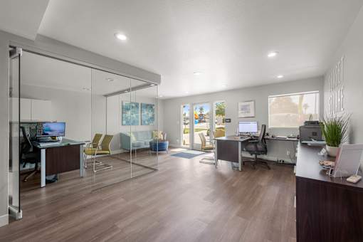 A modern office with glass walls and wooden floors at Sunset Square, West Covina, 91790