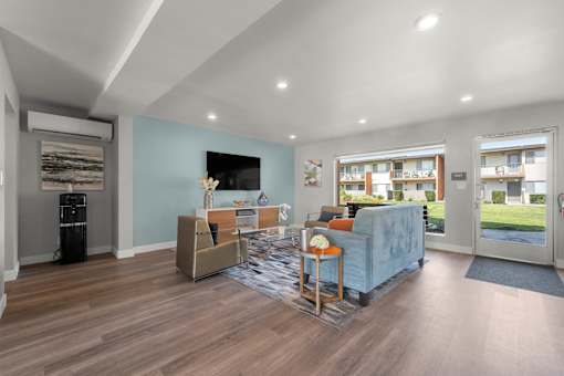 A living room with a blue couch and a television at Sunset Square, West Covina, 91790