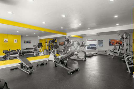 A gym with a variety of equipment including treadmills, weights, and exercise machines at Sunset Square, West Covina, 91790