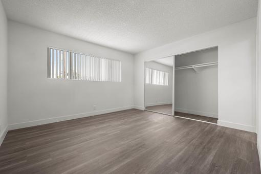 Empty room with wooden floor and white walls at Sunset Square, West Covina, 91790