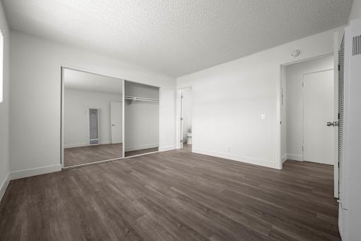 A large empty room with wooden floors and white walls at Sunset Square, West Covina, 91790