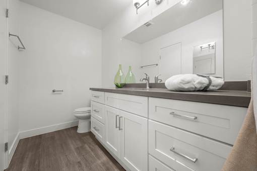 A bathroom with white cabinets and a white toilet at Sunset Square, West Covina, 91790