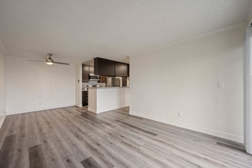 Spacious living room and kitchen with wood flooring at Monterra Ridge Apartments, Canyon Country, CA, 91351