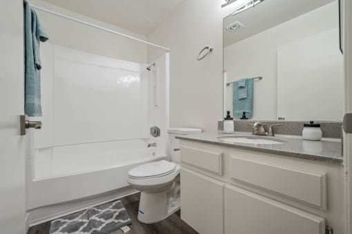 a bathroom with a sink toilet and a shower at Monterra Ridge Apartments, California