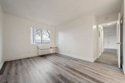 a living room with wood flooring and a window at Monterra Ridge Apartments, Canyon Country ,91351