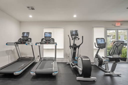 the gym in our new building is equipped with cardio equipment at Monterra Ridge Apartments, Canyon Country, California
