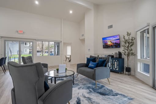 Community clubhouse with two couches and a coffee table at Monterra Ridge Apartments, Canyon Country, CA