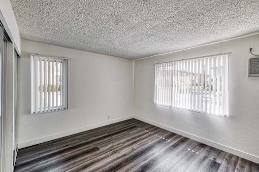 view of bedroom with window blinds at Serrano Apartments, West Covina, CA