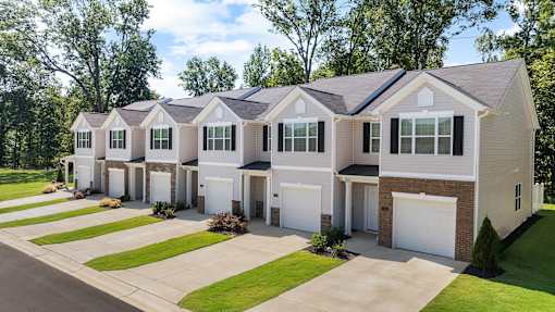 A row of houses with garages in front.