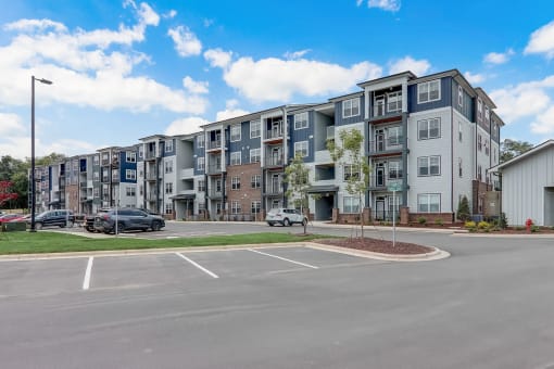 a large parking lot with an apartment building in the background in Asheville NC