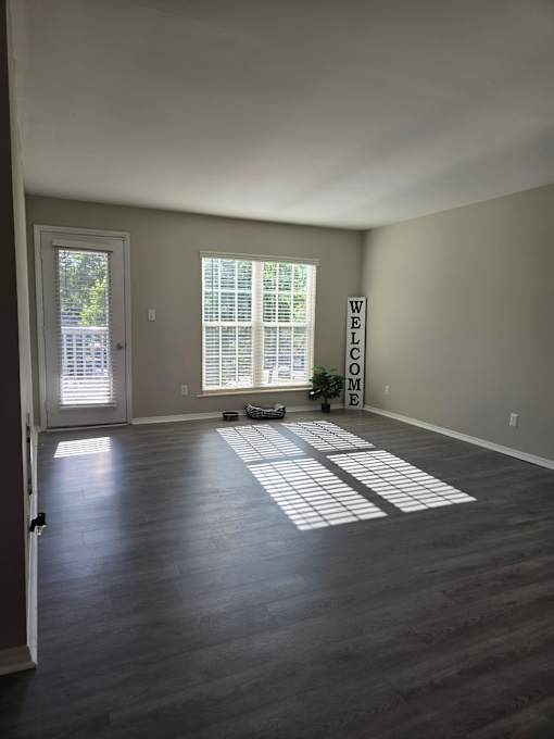 A room with a large window and a sign that says "Welcome".