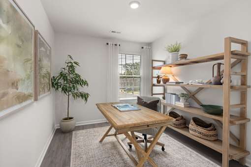 A room with a wooden table and a potted plant.