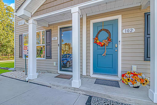 A house with a blue door and a wreath on it.