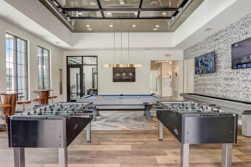 a games room with foosball tables and a ping pong table in Asheville NC
