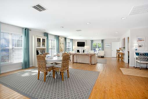 A modern dining room with a table set for four.
