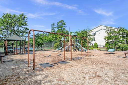 A playground with swings and a slide.