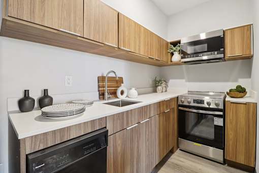 A kitchen with wooden cabinets and stainless steel appliances.